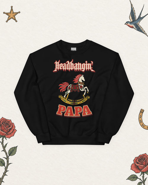 Headbangin' Papa Varsity Crewneck Sweatshirt in Black, product view on pale ivory with faded colored tattoo flash.