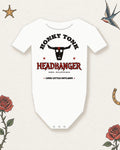 Honky Tonk Headbanger Baby Bodysuit in White, product view on pale ivory with faded colored tattoo flash.
