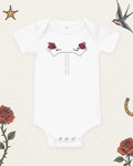 Little Rodeo Suit Baby Bodysuit, Powder Blue Star in White, product view on pale ivory with faded colored tattoo flash.