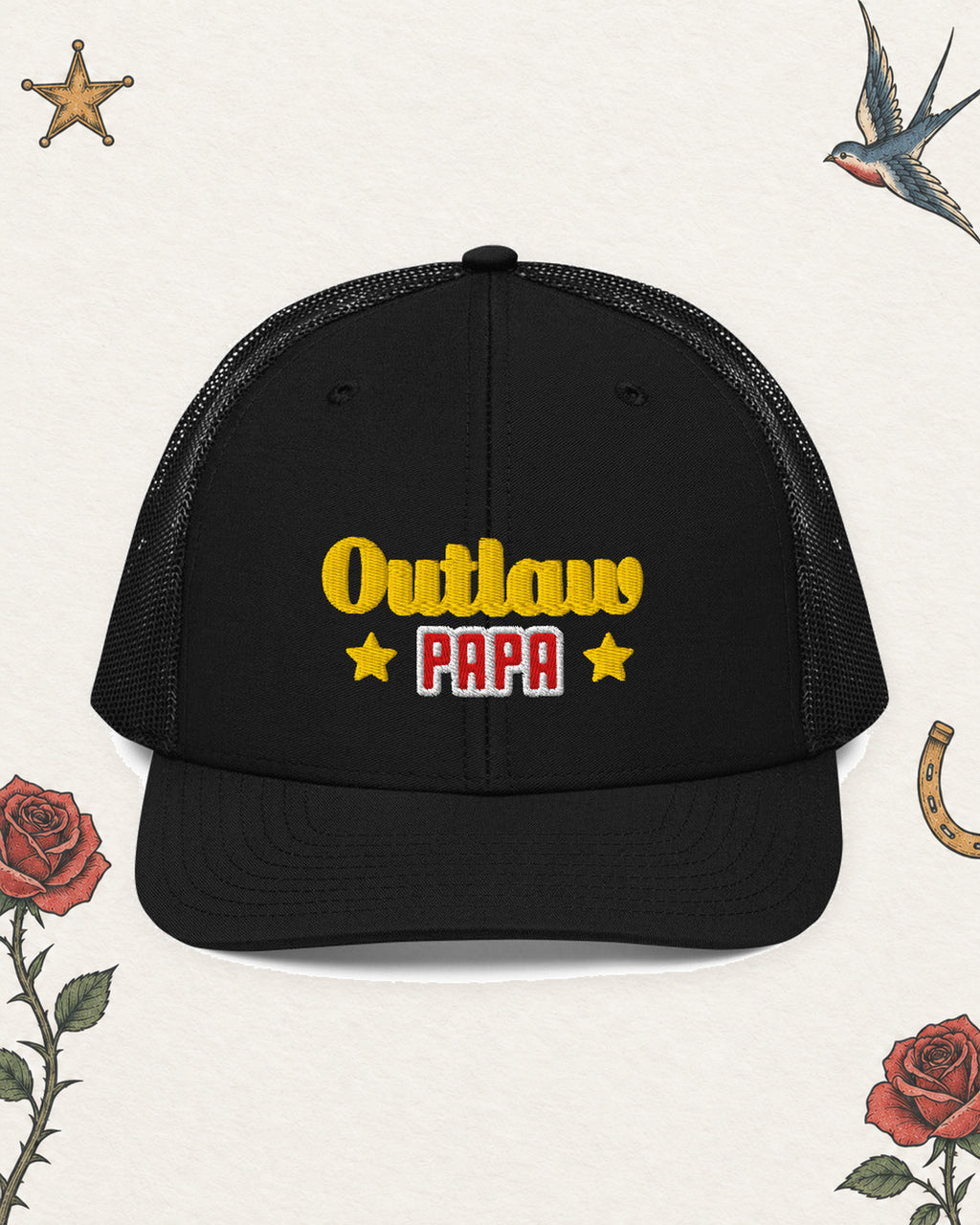 Outlaw Papa Embroidered Trucker Hat in Black, product view on pale ivory with faded colored tattoo flash.