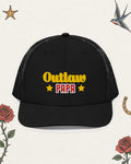 Outlaw Papa Embroidered Trucker Hat in Black, product view on pale ivory with faded colored tattoo flash.