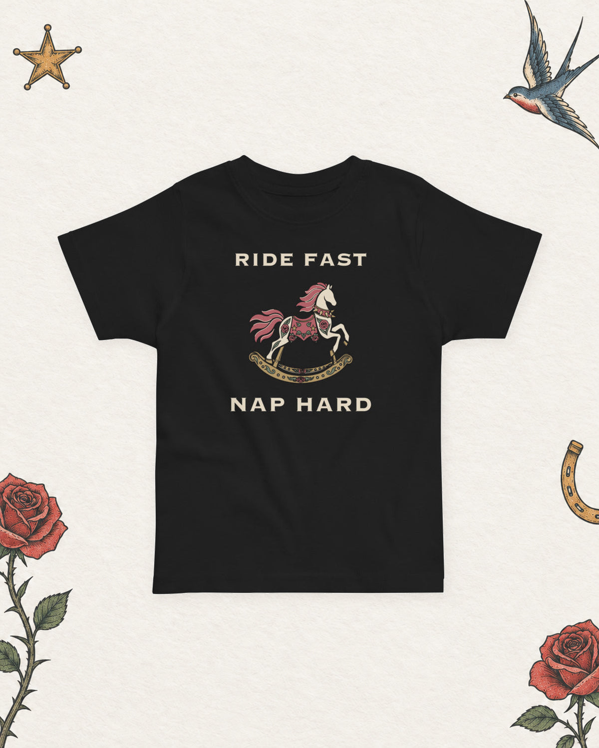 Ride Fast, Nap Hard Toddler Tee in Black, product view on pale ivory with faded colored tattoo flash.