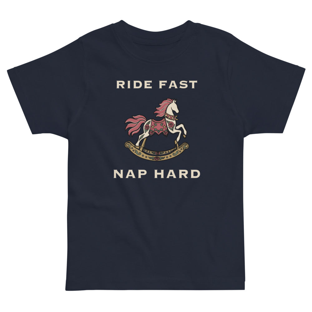 Ride Fast, Nap Hard Toddler Tee, navy, rose-trimmed rocking horse and Ride Fast, Nap Hard lettering, product view.