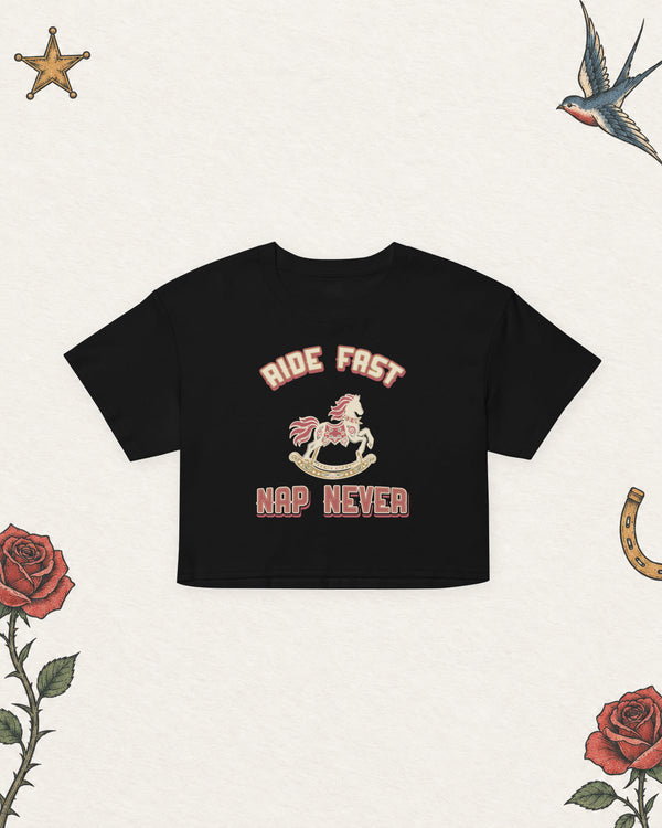Ride Fast, Nap Never Women's Crop Top in Black, product view on pale ivory with faded colored tattoo flash.