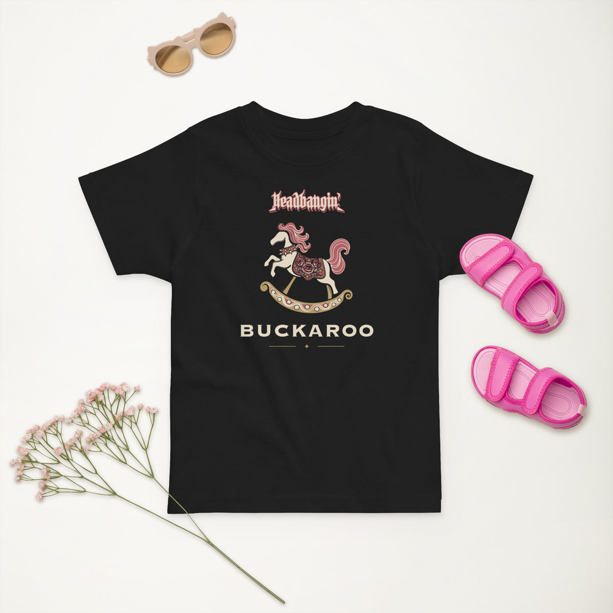 Headbangin' Buckaroo Toddler Tee in Black, styled flat lay