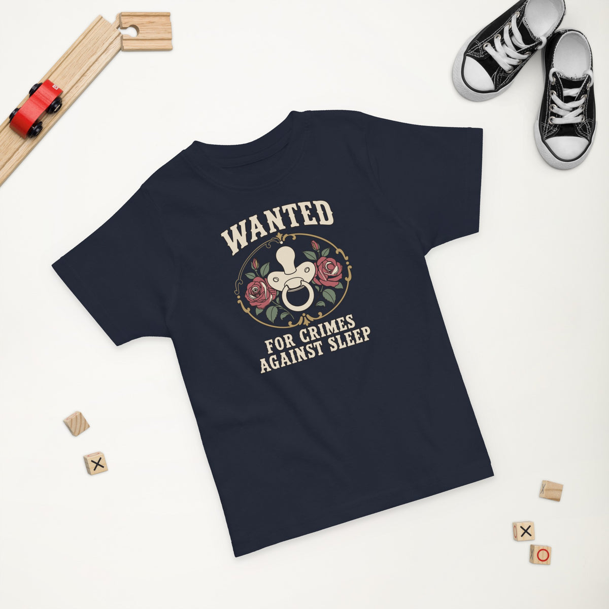 Wanted: For Crimes Against Sleep Toddler Tee in Navy, styled flat lay, second angle