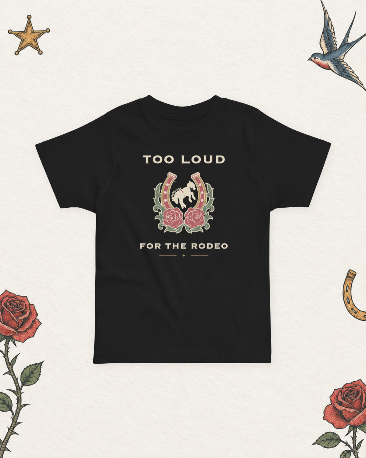 Too Loud for the Rodeo Toddler Tee in Black, product view on pale ivory with faded colored tattoo flash.