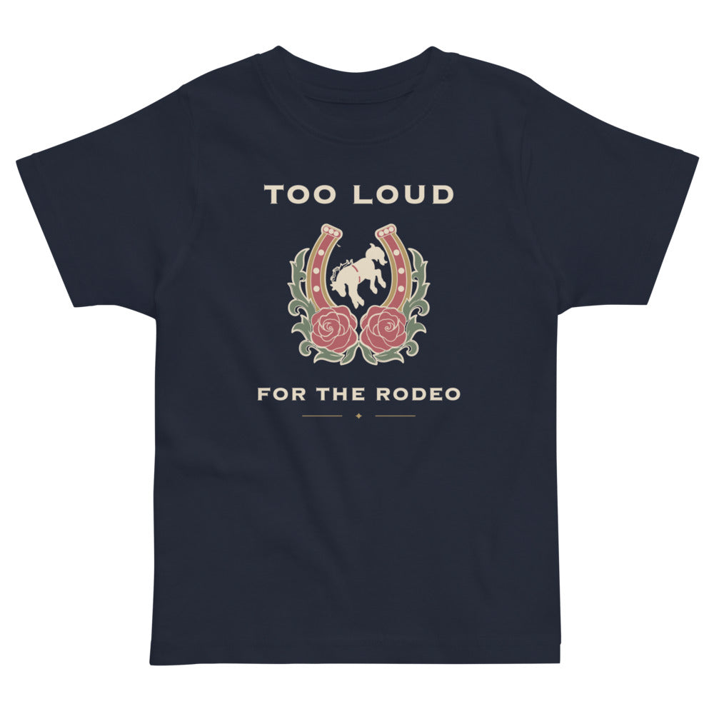 Too Loud for the Rodeo Toddler Tee, navy, rearing horse inside a rose-trimmed horseshoe, product view.