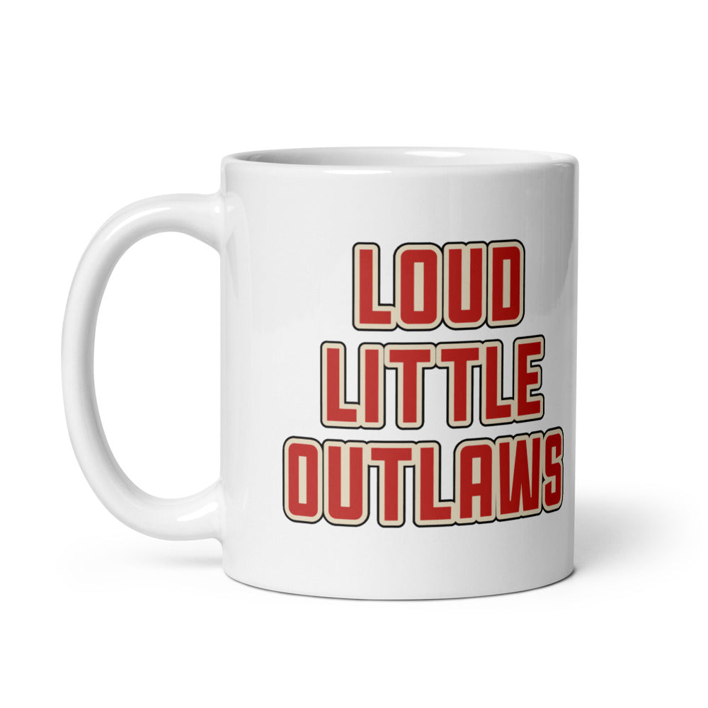 Loud Little Outlaws Rose Mug, white, red Loud Little Outlaws wordmark on one side and tattoo-flash rose on the other, handle on left.